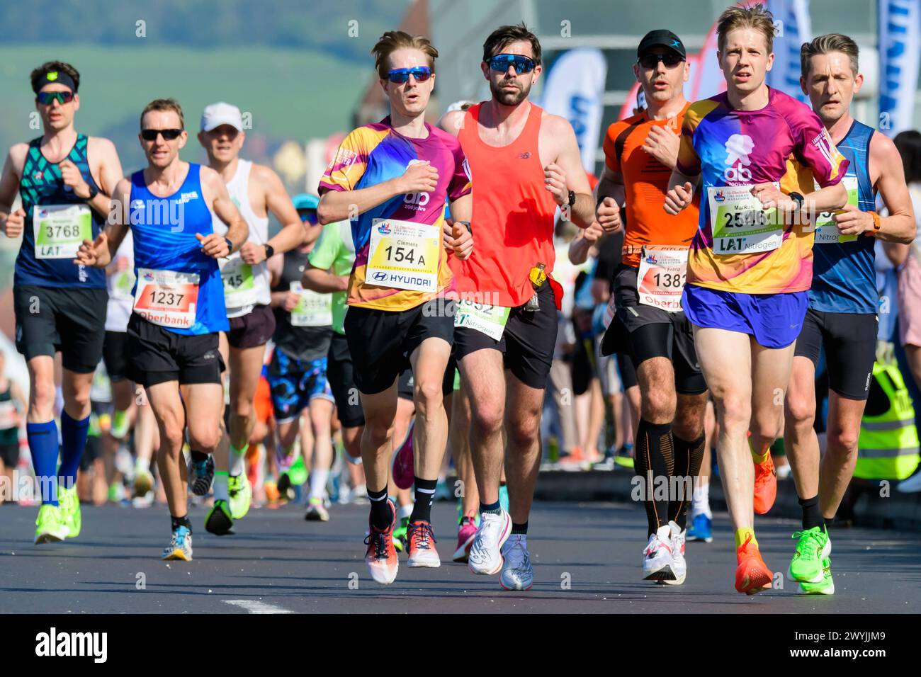 linz, austria, 07 april 2024, competitors of the linz marathon crossing