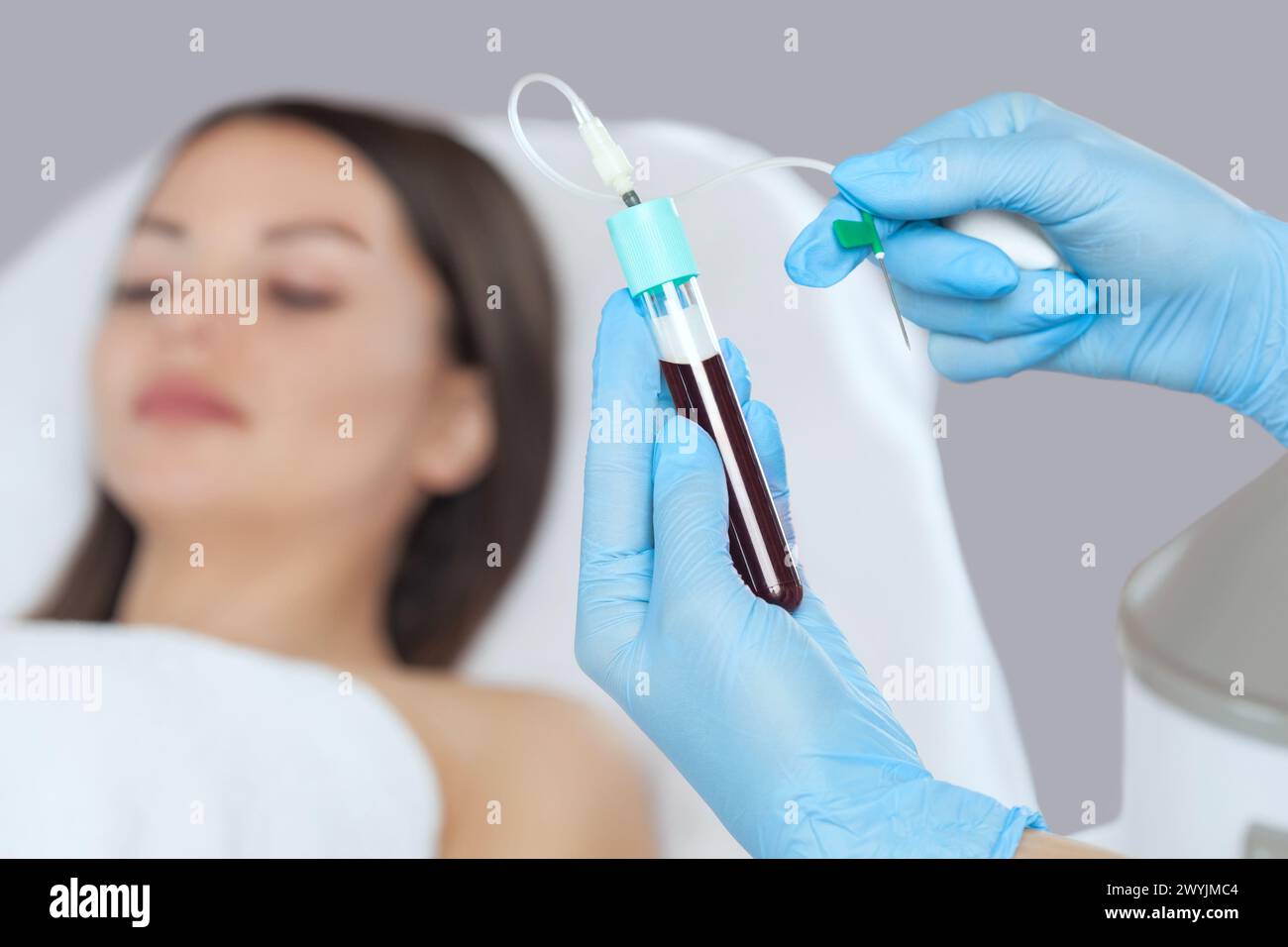 The blood tube is removed to the medical centrifuge for plasma lifting. Prp procedure and cosmetology concept. Stock Photo