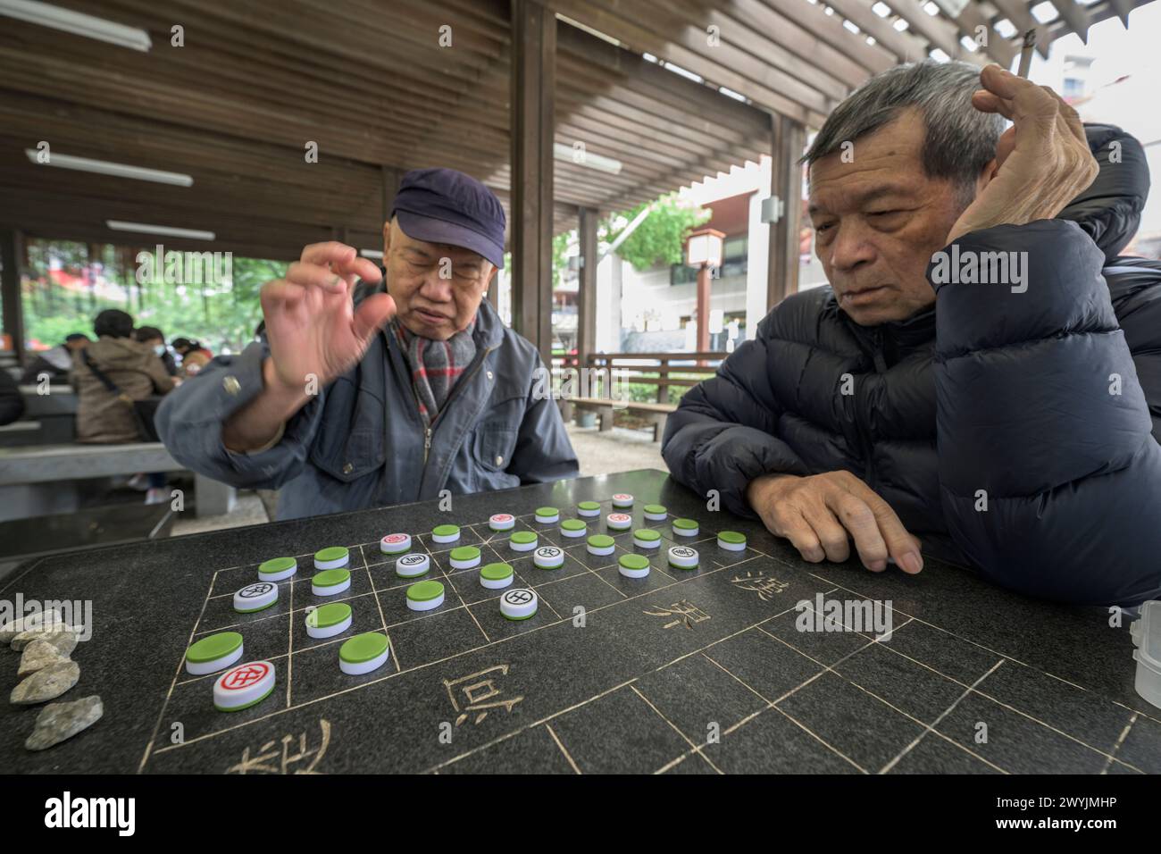Senior men deeply focused on a strategic board game Stock Photo