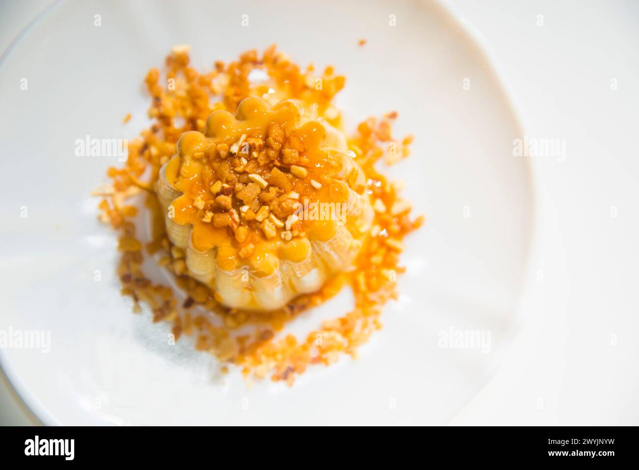 Creme caramel with chopped almonds. View from above. Stock Photo