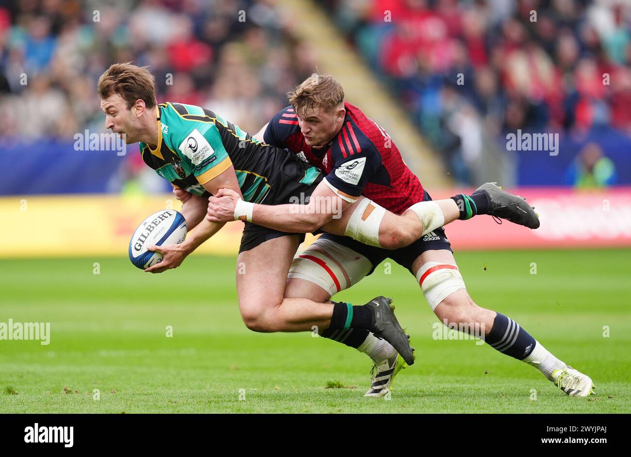 Northampton Saints' James Ranm is tackled by Munster's Gavin Coombes during the ECPR Challenge Cup match at cinch Stadium at Franklin's Gardens, Northampton. Picture date: Sunday April 7, 2024. Stock Photo