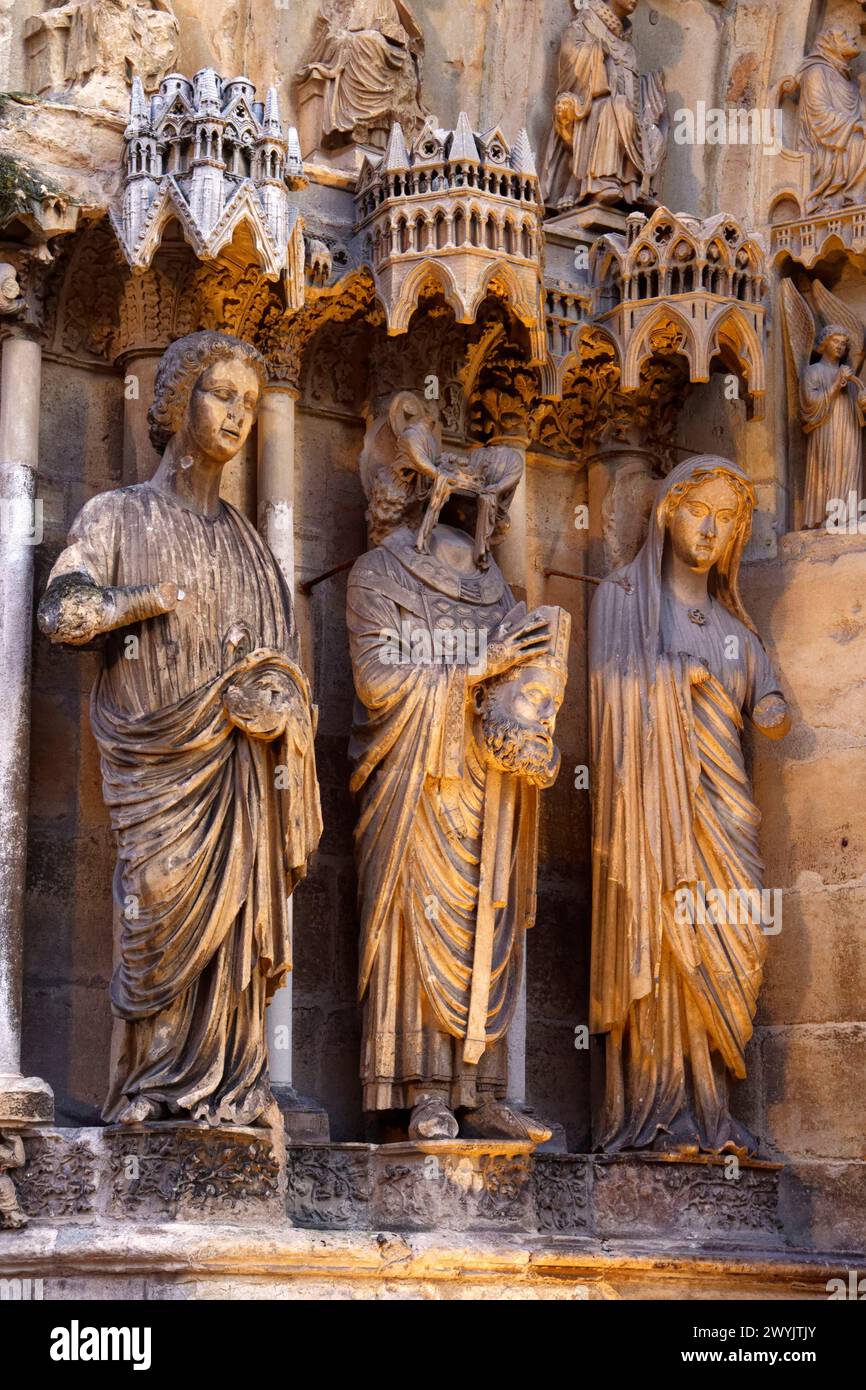 France, Marne, Reims, Notre Dame cathedral, listed as World Heritage by UNESCO, the northen frontage, northern portal, tympanum, statuary telling the life of Saint Remi and Saint Nicaise, beheaded by vandals in 407 Stock Photo