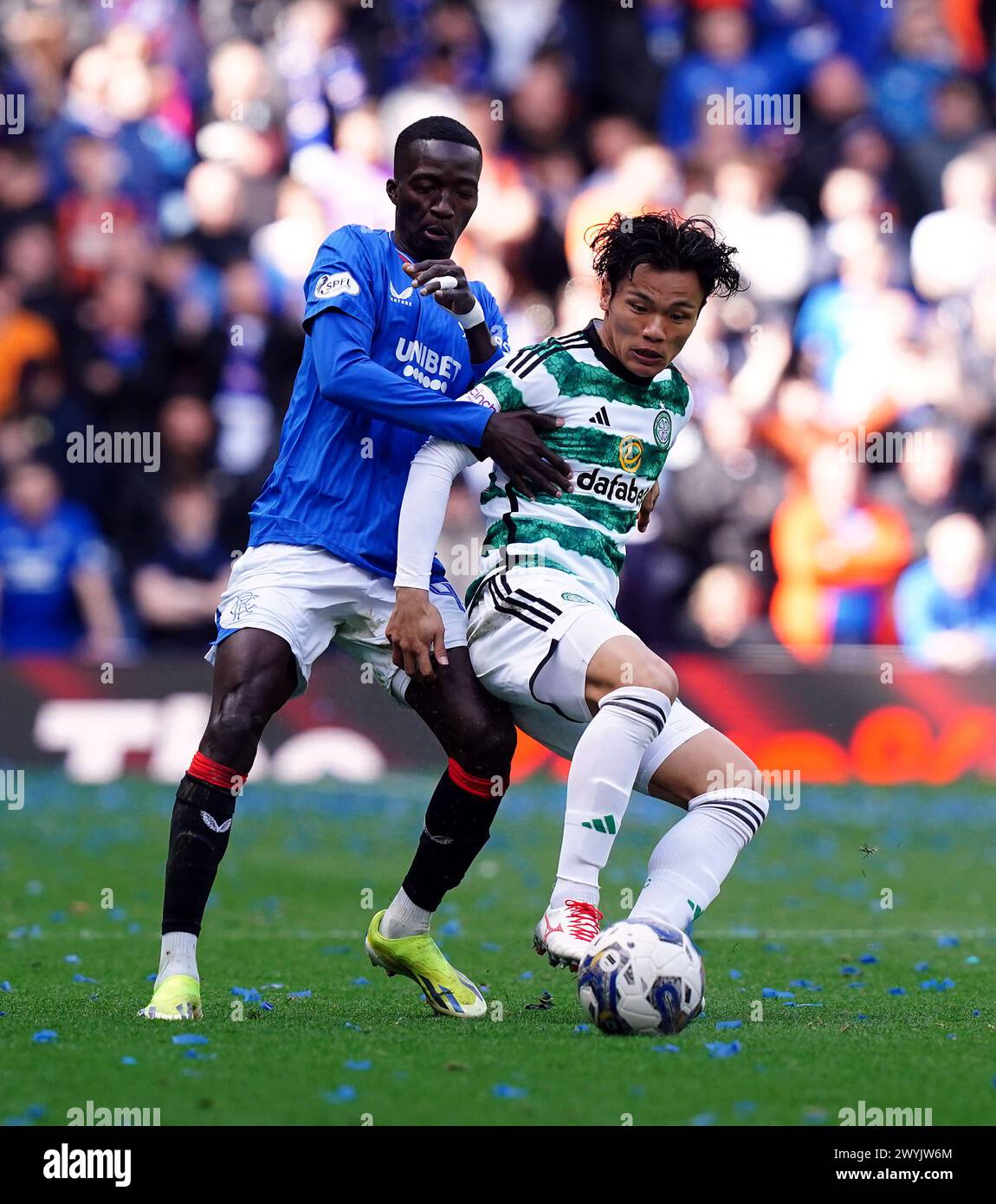 Rangers' Mohamed Diomande And Celtic's Reo Hatate (right) Battle For 