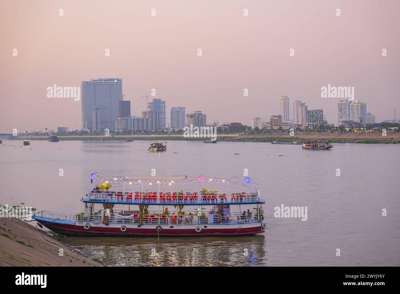 Cambodia, Phnom Penh, tourist boat on the Tonle Sap river and the buildings of the Chroy Changvar district Stock Photo
