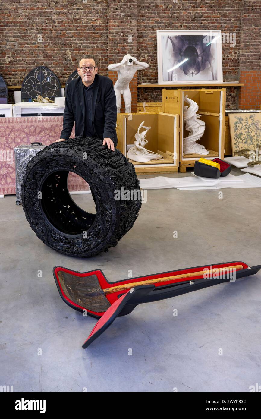 Belgium, East Flanders, Ghent, Studio Wim Delvoye, the artist Wim Delvoye with handcarved car tyre Stock Photo