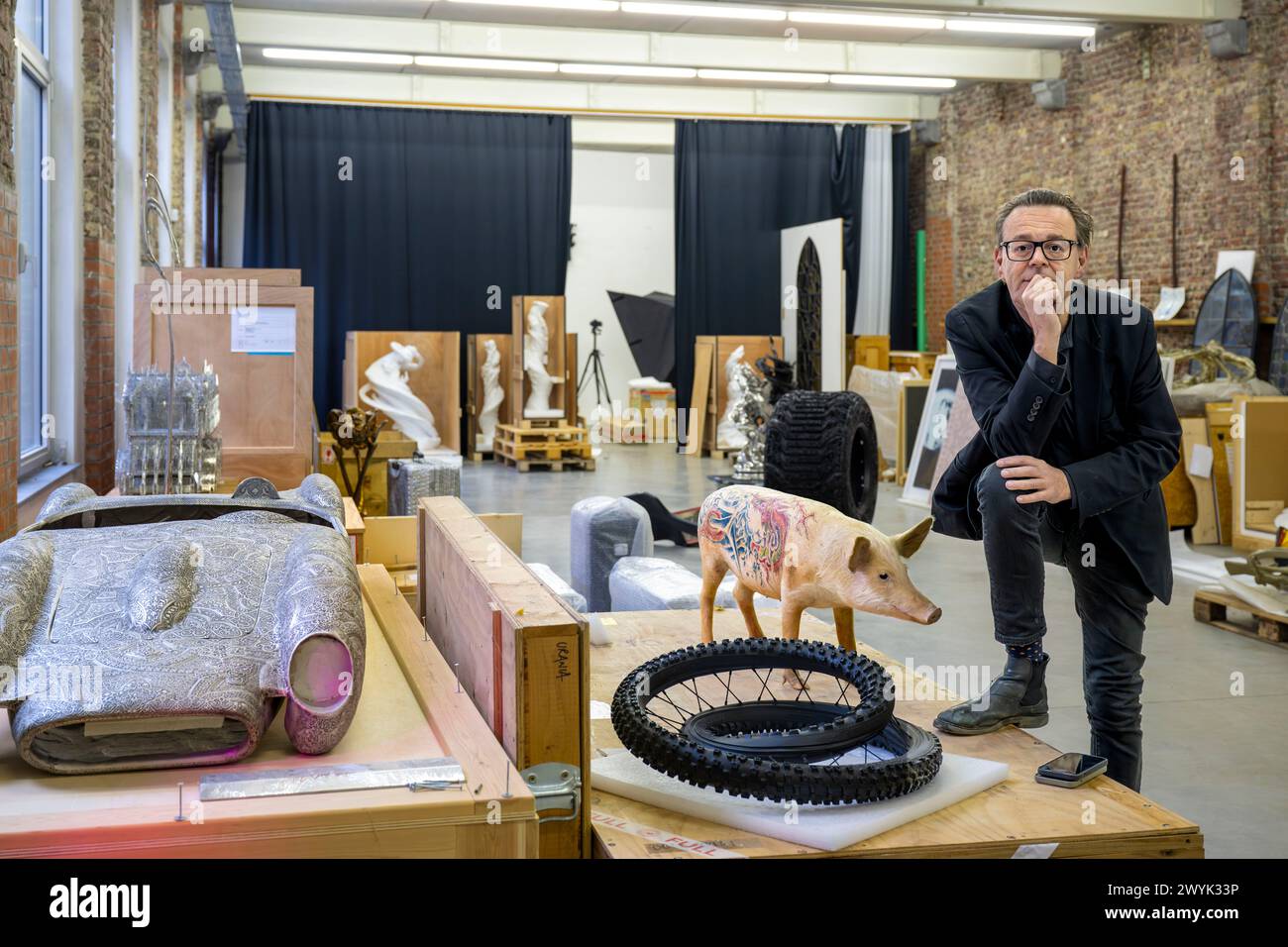 Belgium, East Flanders, Ghent, Studio Wim Delvoye, the artist Wim Delvoye with one of his stuffed tattooed pigs Stock Photo