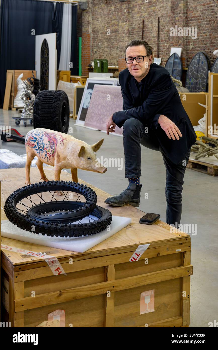 Belgium, East Flanders, Ghent, Studio Wim Delvoye, the artist Wim Delvoye with one of his stuffed tattooed pigs Stock Photo