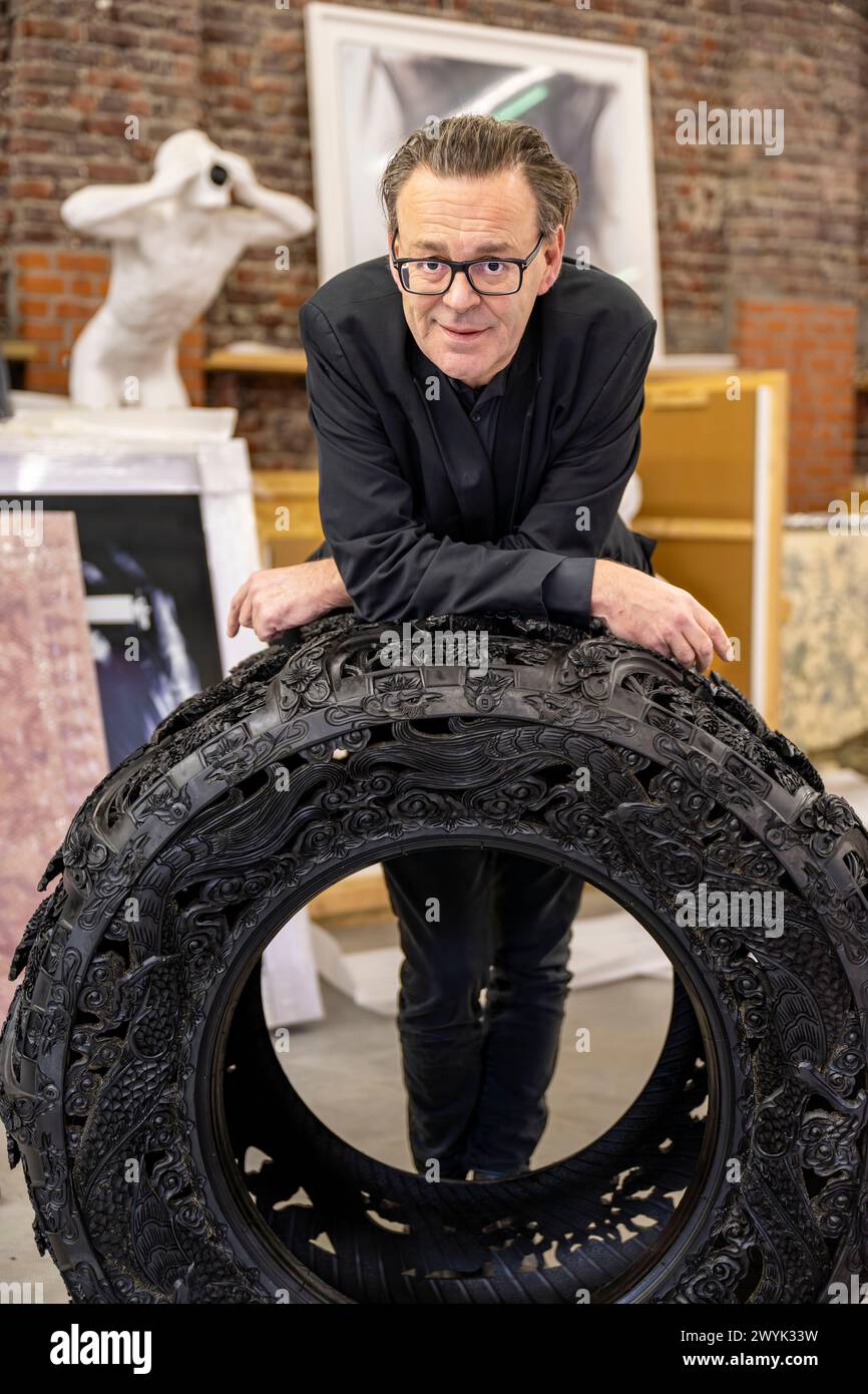 Belgium, East Flanders, Ghent, Studio Wim Delvoye, the artist Wim Delvoye with handcarved car tyre Stock Photo