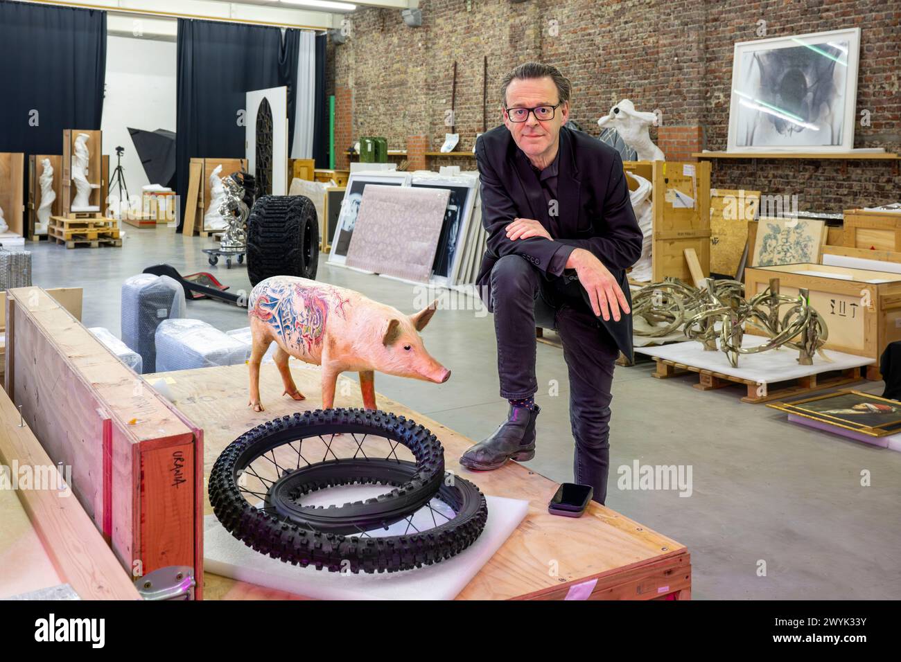 Belgium, East Flanders, Ghent, Studio Wim Delvoye, the artist Wim Delvoye with one of his stuffed tattooed pigs Stock Photo