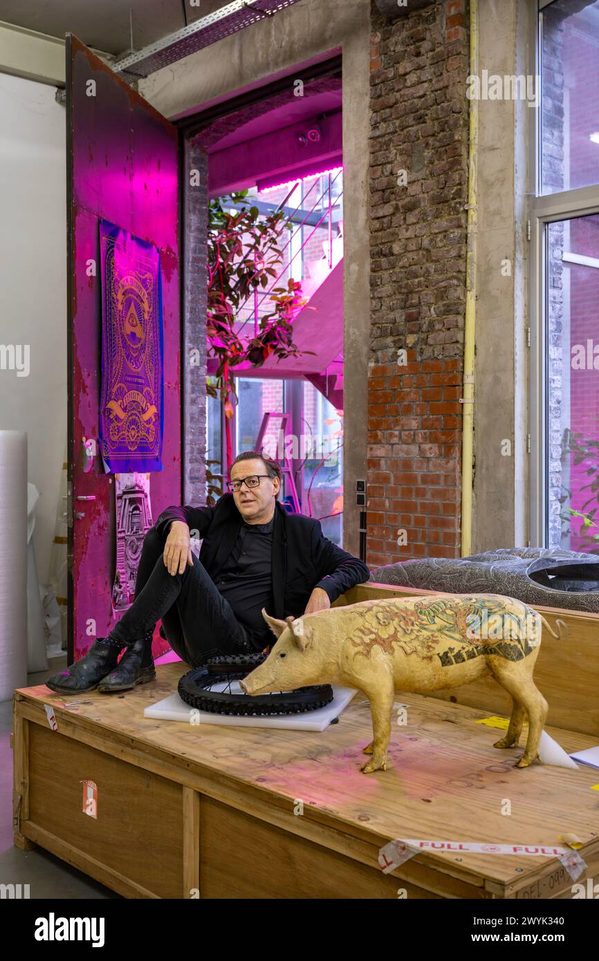 Belgium, East Flanders, Ghent, Studio Wim Delvoye, the artist Wim Delvoye with one of his stuffed tattooed pigs Stock Photo
