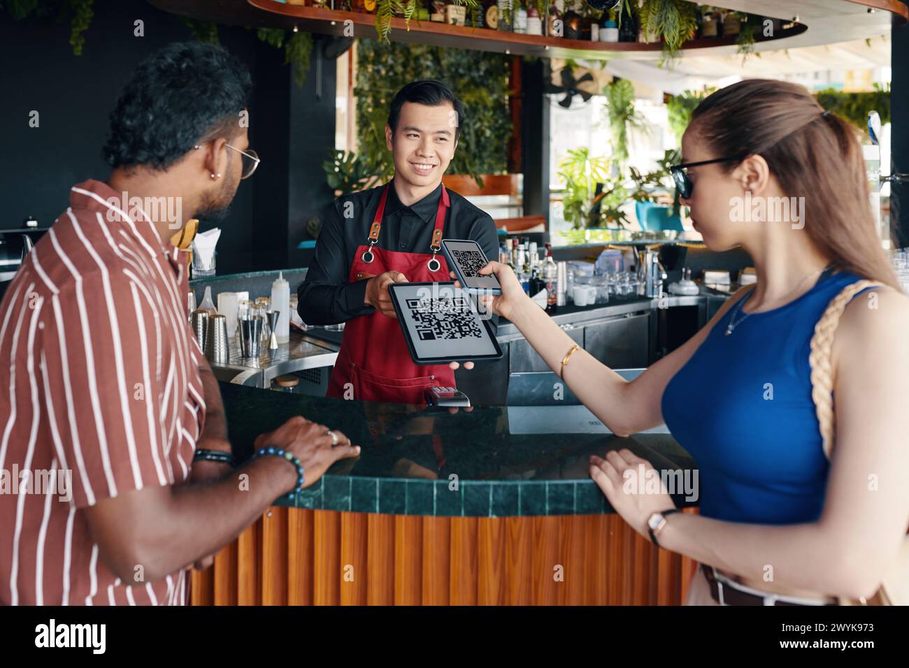 Woman scanning qr code when paying for order in restaurant Stock Photo ...
