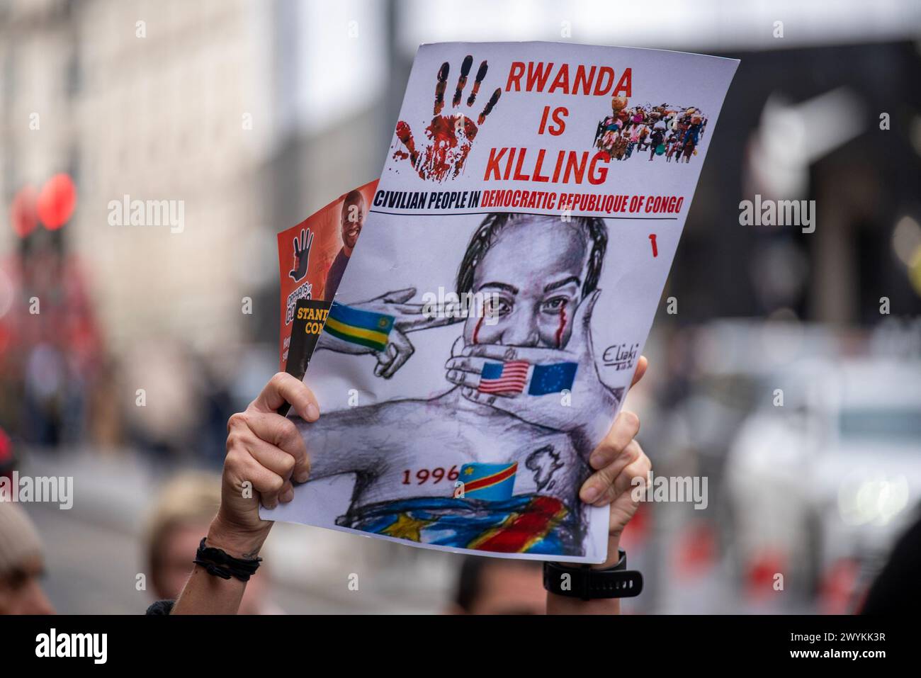 London, UK. 6th Apr, 2024. A protester holds a placard outside the Apple HQ in London. Congolese diaspora and their allies protested front of the London HQ of Apple against the violence and the mineral exploitation in Eastern part of the Democratic Republic of Congo (DRC), where the fights is going on between the Congolese forces and the Rwanda backed M23 rebel group. The conflict created a growing refugee crisis, human right abuses and cheap labor for mining. All minerals like Coltan, Cobalt, etc. which are used by companies like Apple on phones and batteries. (Credit Image: © Kri Stock Photo