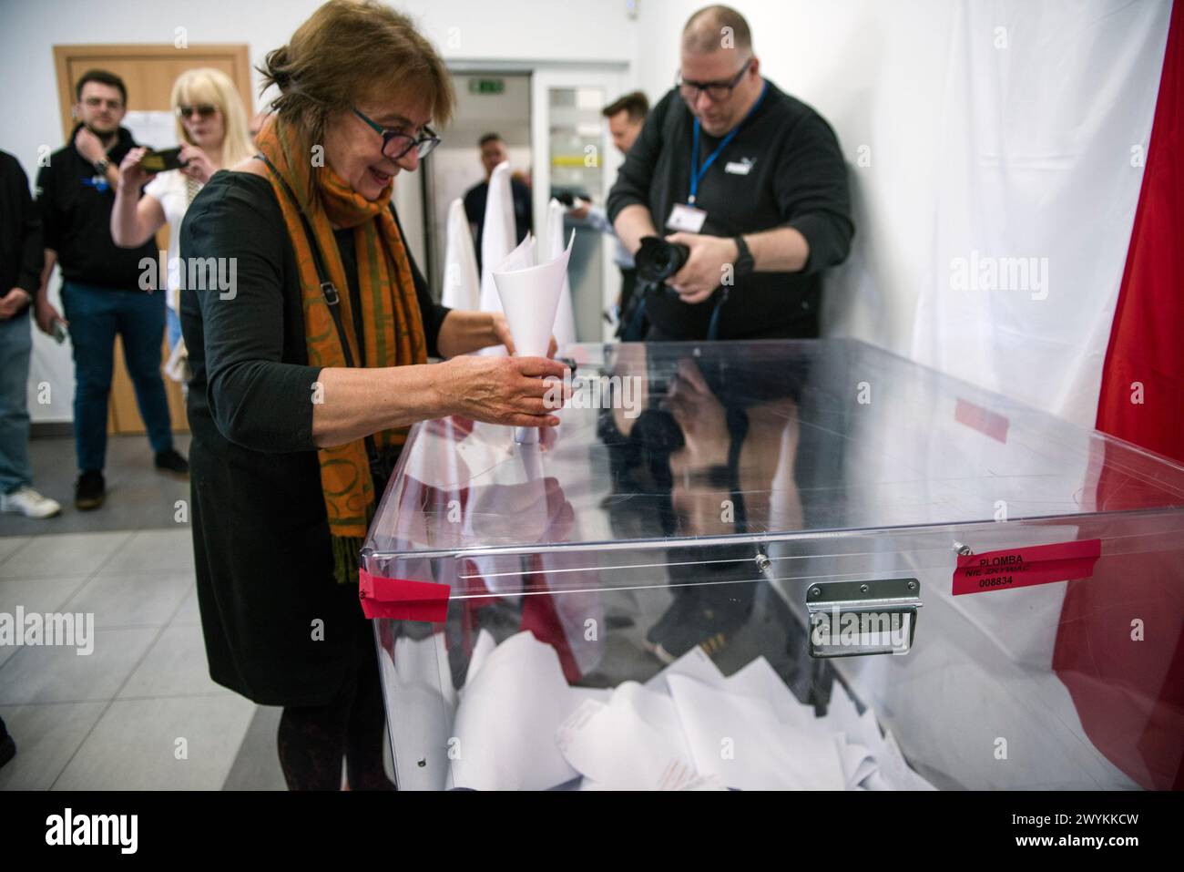 A woman casts her vote at the polling station during the local elections. Voters across Poland are casting ballots in local elections in the first electoral test for the coalition government of PM Donald Tusk nearly four months since it took power. Voters elected mayors as well as members of municipal councils and provincial assemblies. Among those running is Rafal Trzaskowski - Mayor of Warsaw, a Tusk ally who is seeking a second term. Opinion polls showed the two largest political formations running neck-and-neck: Tusk's Civic Coalition, an electoral coalition led by his centrist and pro-Eu Stock Photo
