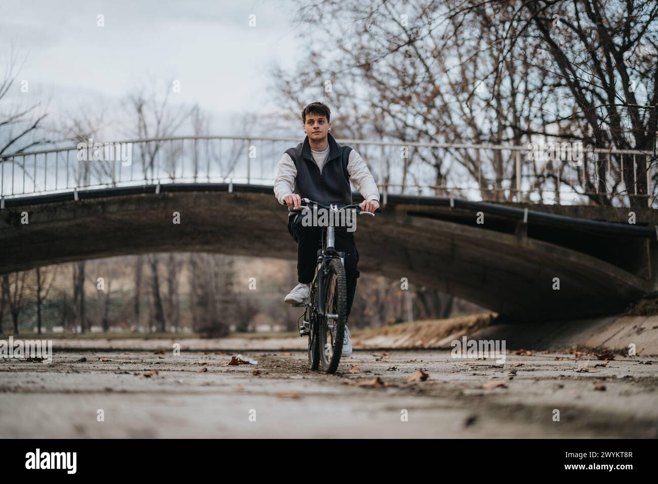 Teenage boy enjoying a leisurely bike ride in a scenic park Stock Photo ...