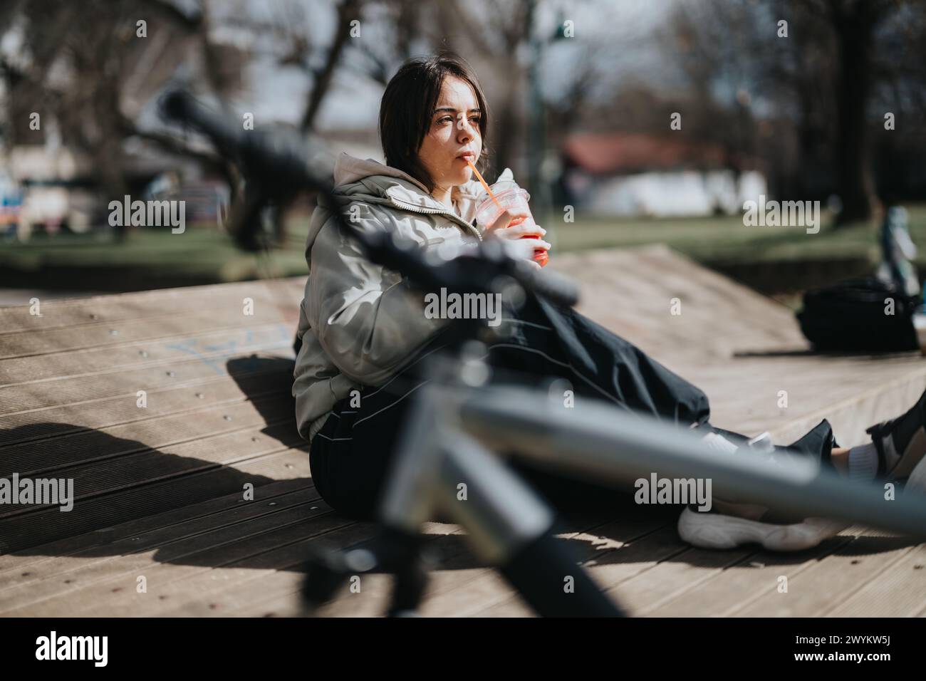 Young woman enjoying a sunny day in the park with her bicycle Stock ...