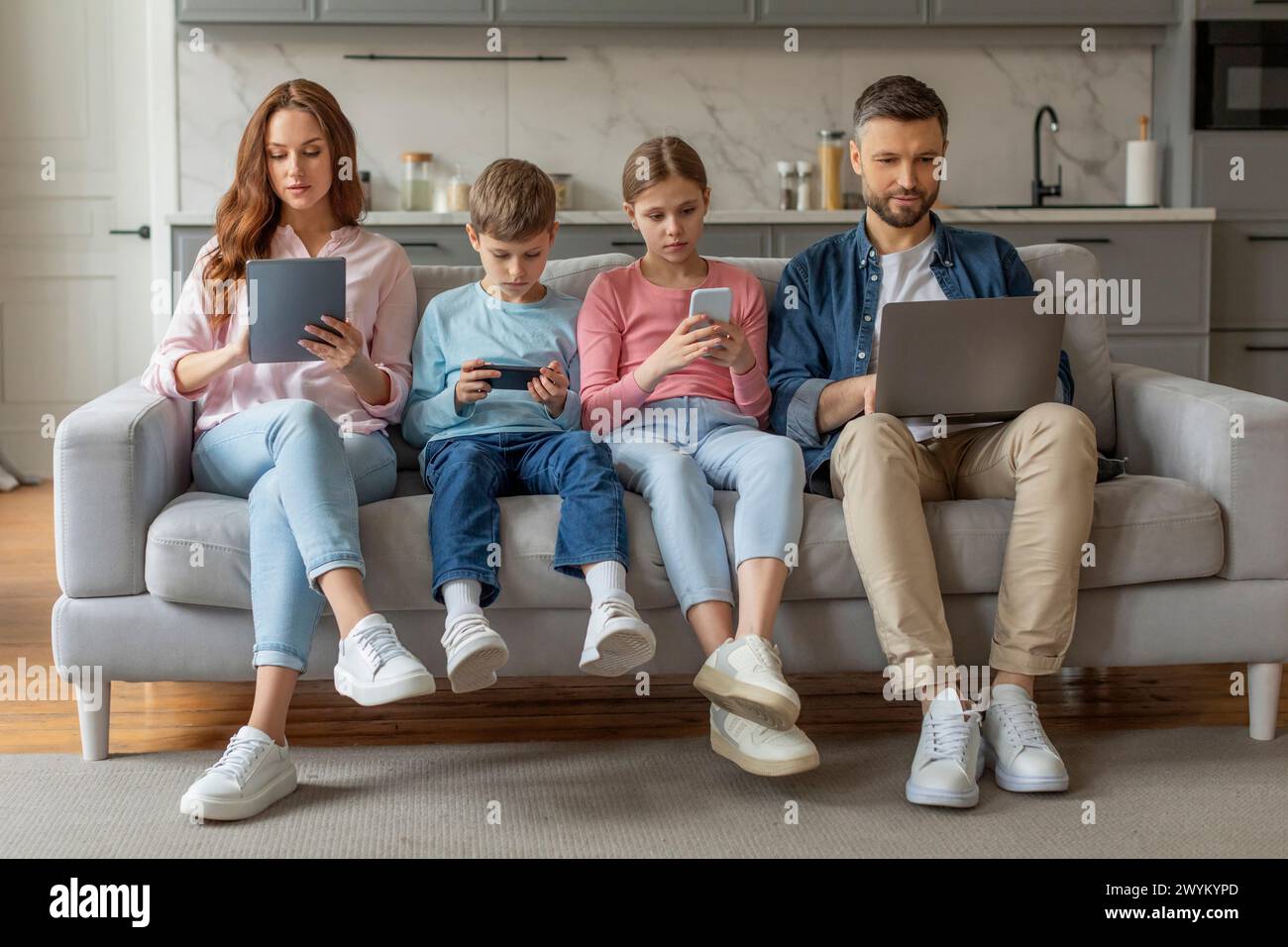 Technology gadgets addicted family hi-res stock photography and images ...