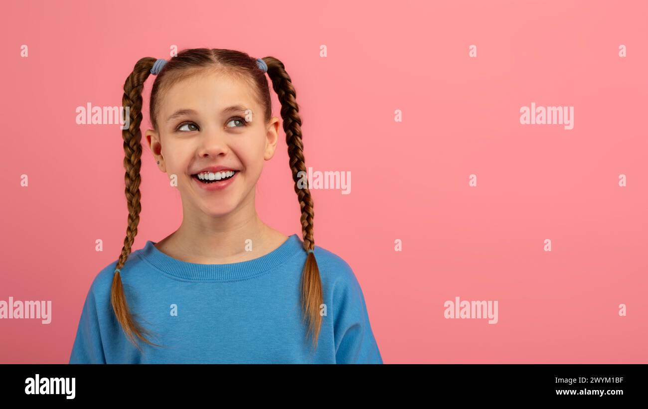 Smiling girl with braids against pink background Stock Photo - Alamy