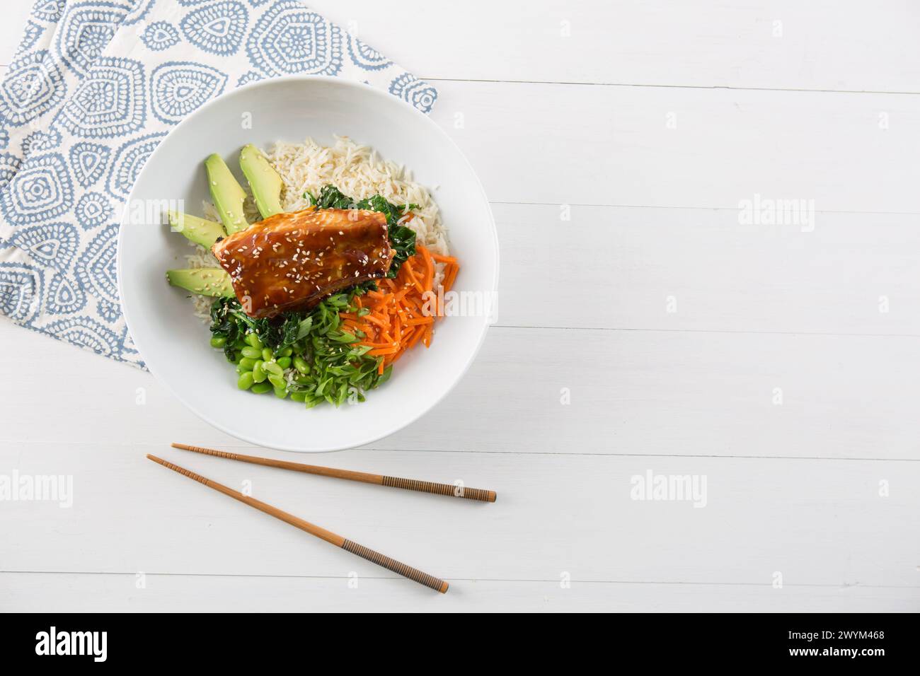 poke bowl asian style with salmon and vegetables, space for copy and chopsticks Stock Photo