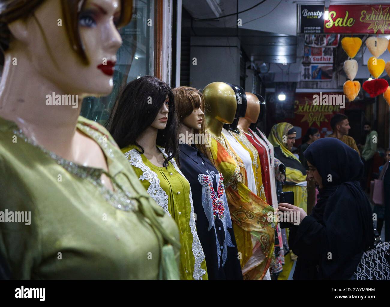April 07, 2024, Srinagar, India A woman shops in a fabric store ahead