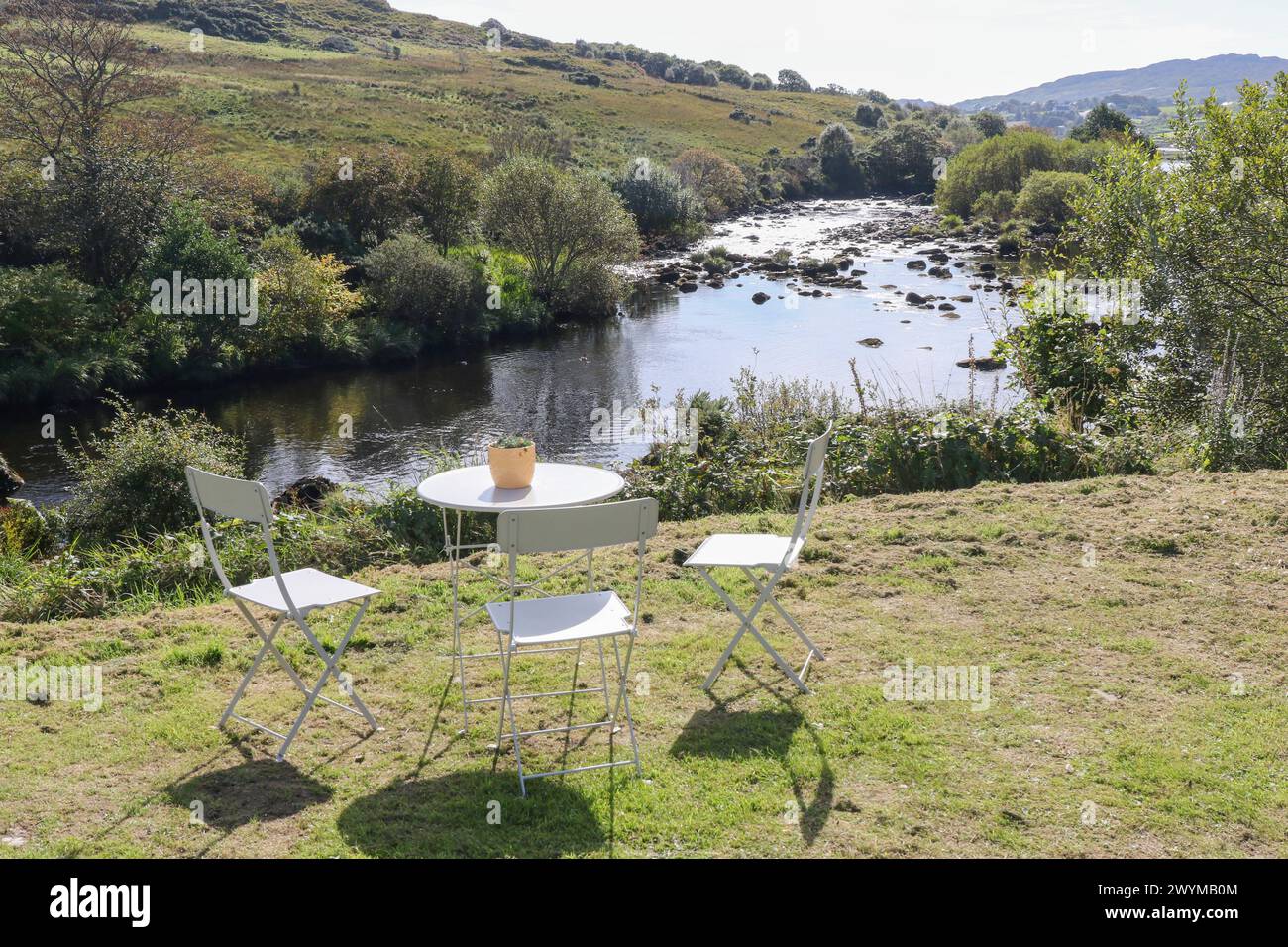 Folding table chairs beside salmon pool Glen River Teelin Donegal, Ireland. Stock Photo