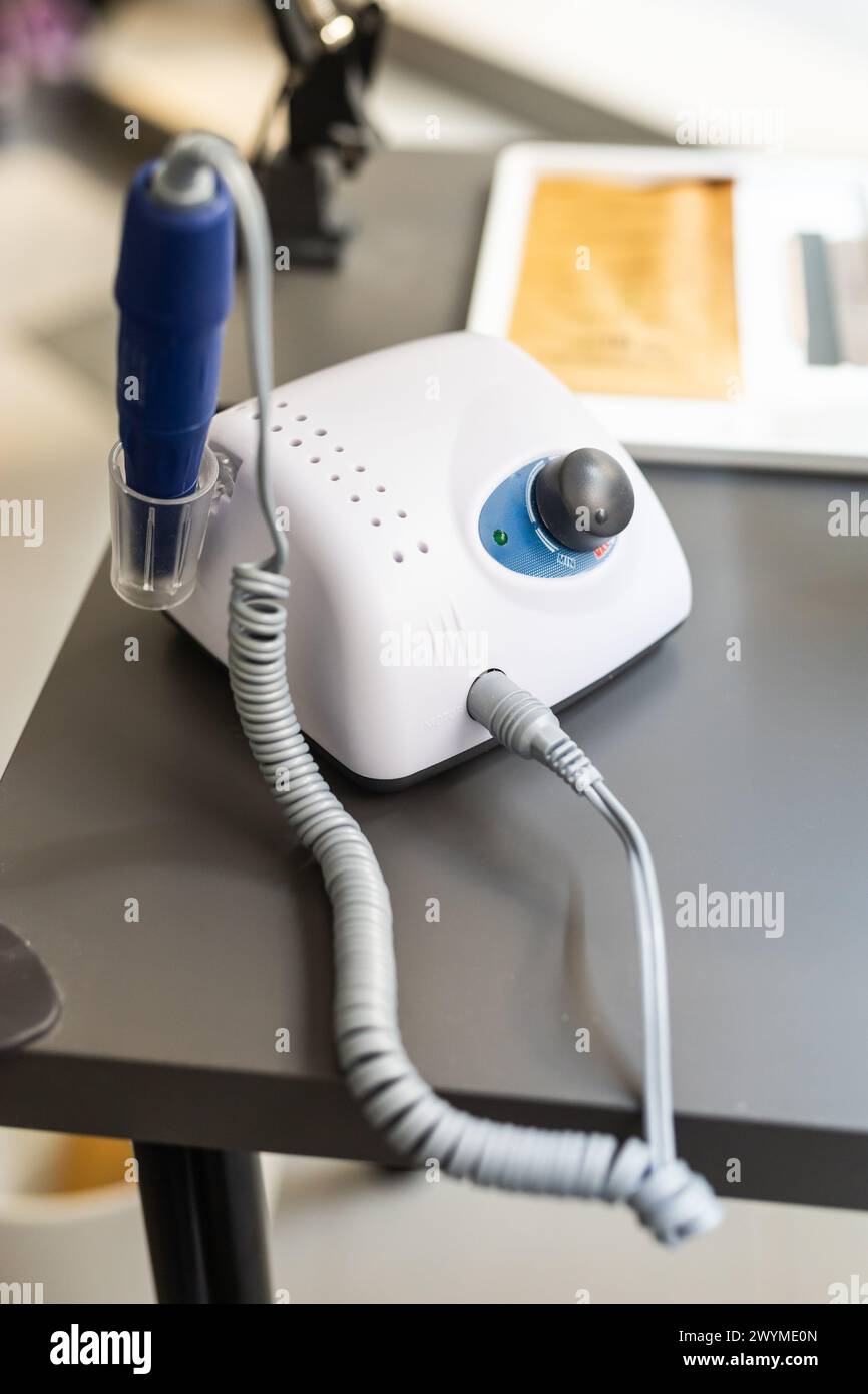 Electric manicure machine on table. Drill for manicure Stock Photo