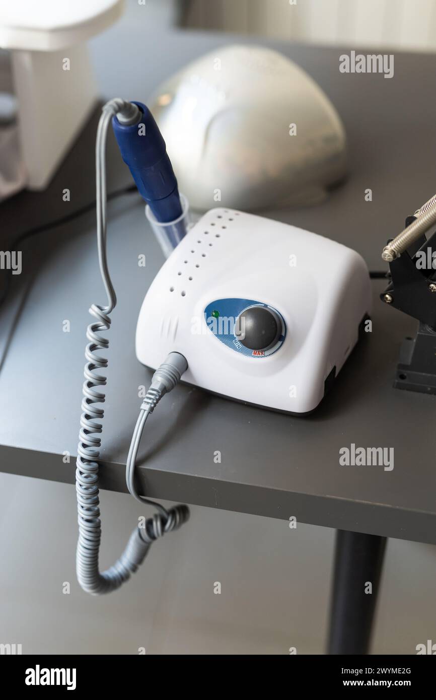Electric manicure machine on table. Drill for manicure Stock Photo