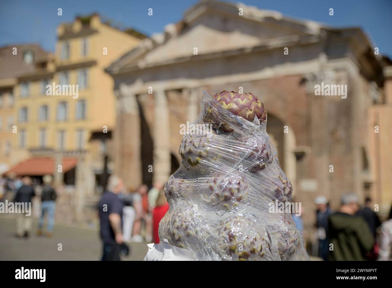 April 7, 2024, Rome, Italy: The tip of a cone made with artichoke heads covered in cellophane and in the background the Portico of Octavia on the occasion of the Roman Artichoke Festival in Rome. The Roman Artichoke Festival has begun in the former Jewish Ghetto in Rome. The Roman Artichoke is a typical variety of the Lazio region, in addition to being a cornerstone of the Mediterranean diet, it is a fundamental ingredient of the Roman and Judeo-Roman culinary tradition, which has seen its use in numerous recipes, famous throughout the world. (Credit Image: © Marcello Valeri/ZUMA Press Wire) E Stock Photo