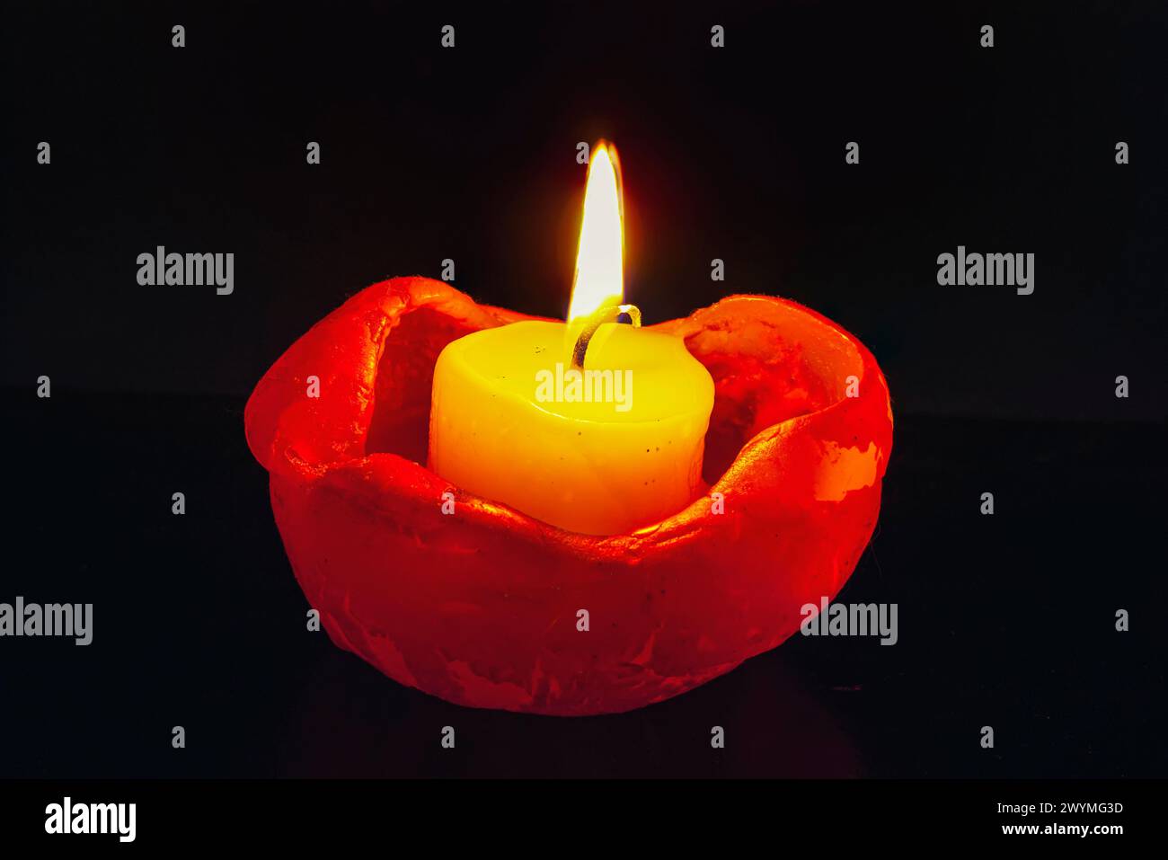 Close up of single burning candle light on black background. Candle ...