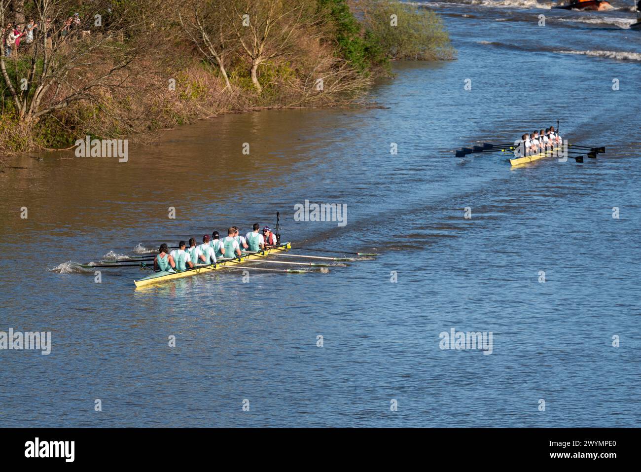 University Boat Race Men's race teams approach finish line with chase boats. Cambridge leading Oxford through Mortlake to finish near Chiswick Bridge Stock Photo