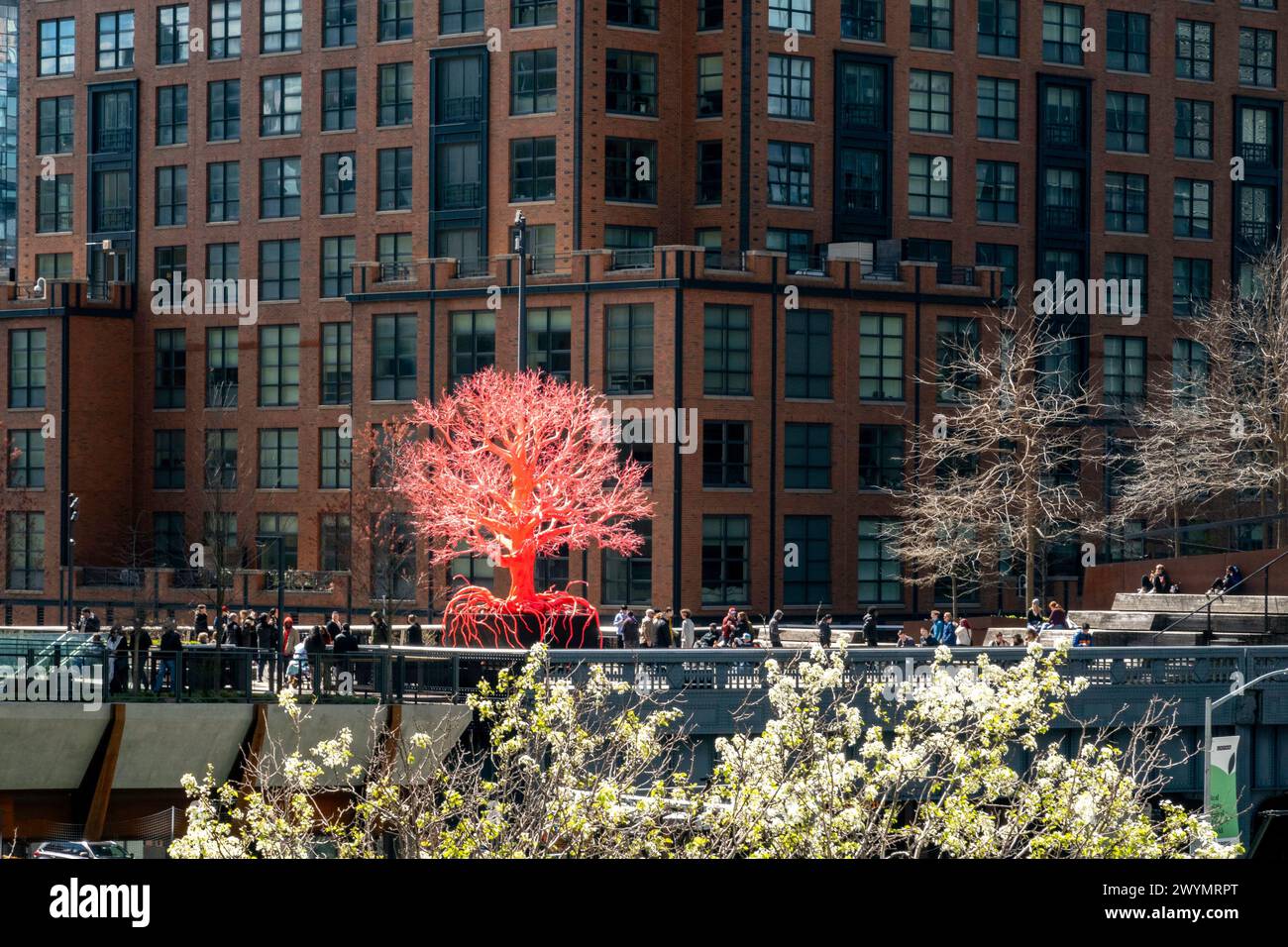 The old tree is a pink and red 25 foot tall sculpture comprised of man-made materials on display on the Highline, 2024, NYC, USA Stock Photo
