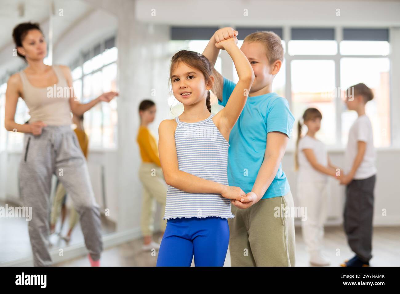 Girl paired up with boy and training to perform slow couple dance ...
