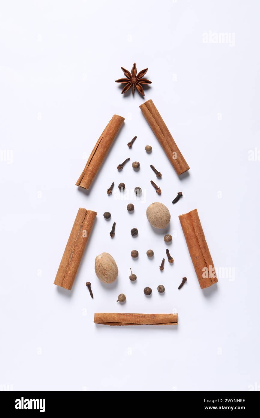 Christmas tree made of different spices on white table, flat lay Stock Photo