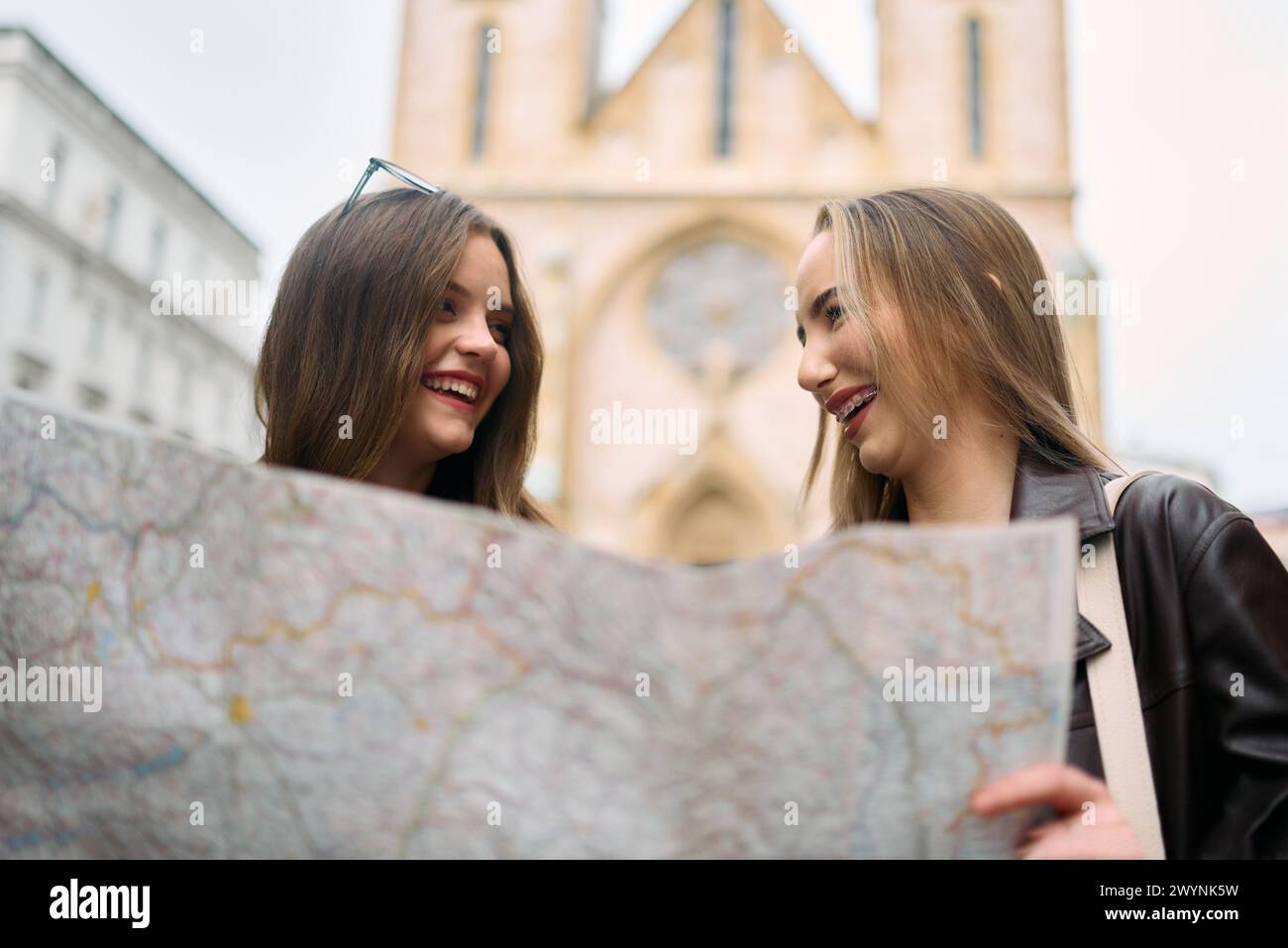 Two female tourists engage in lively discussion, surrounded by their ...