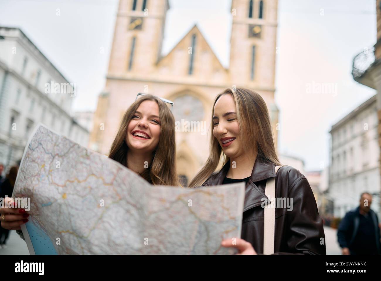 Two female tourists engage in lively discussion, surrounded by their ...
