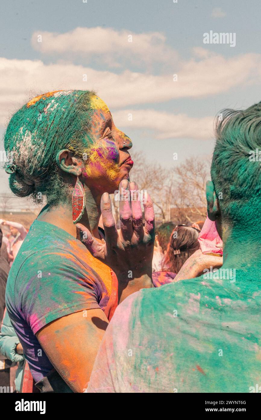 Queens, USA. 07th Apr, 2024. People gather for the 36th annual Phagwah/Holi festival in Richmond Hill, Queens, NY, on Sunday, April 7, 2024. Holi, also known as Phagwah, is a Hindu celebration of color to welcome the spring equinox. People from Trinidad and Tobago, Grenada, Suriname and Guyana display their flags as these nations are home to a significant percentage of Hindu worshipers outside India. (Photo by Cristina Matuozzi/Sipa USA) Credit: Sipa USA/Alamy Live News Stock Photo