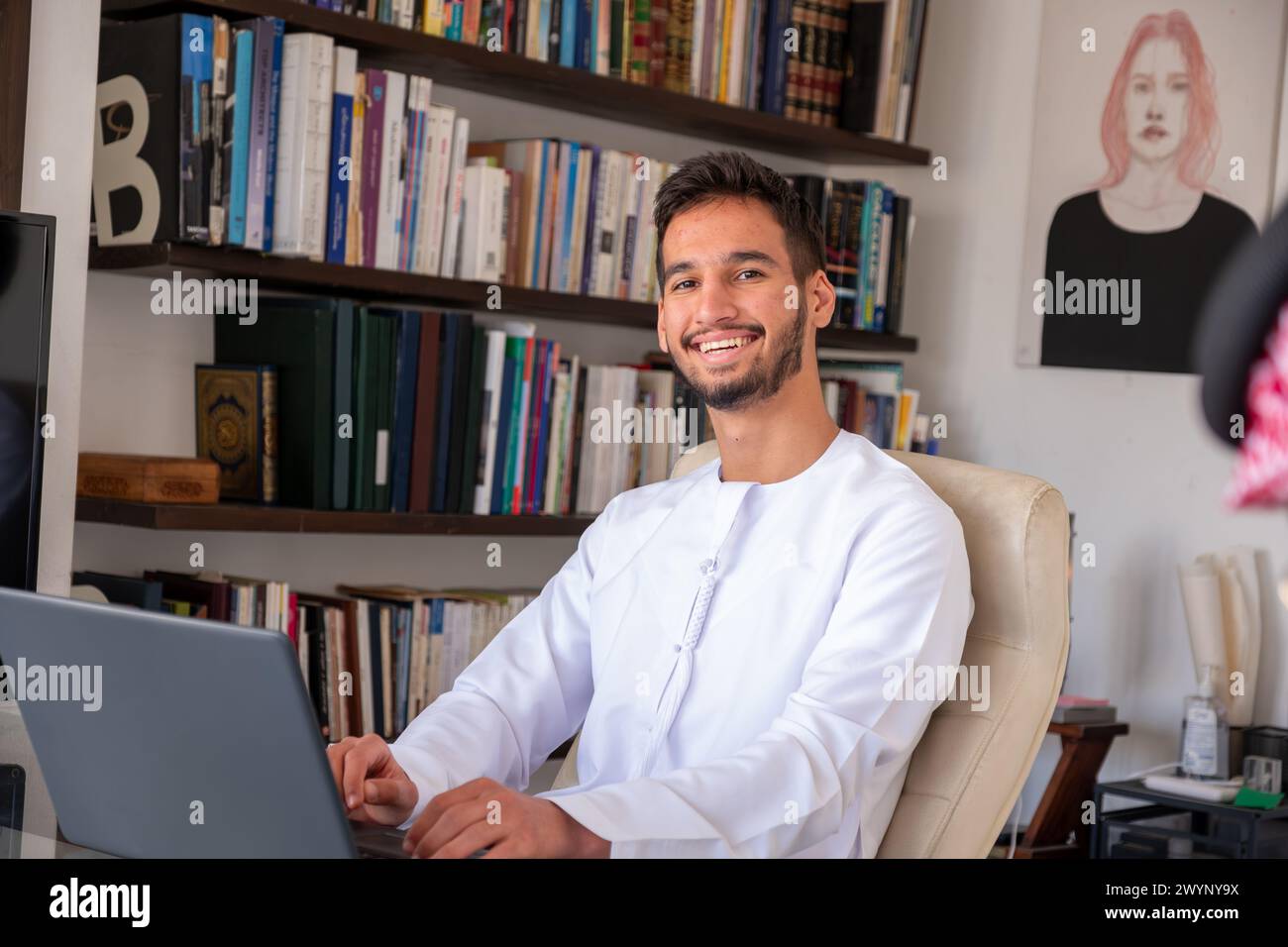confident arabic male working on his laptop with modern background and ...