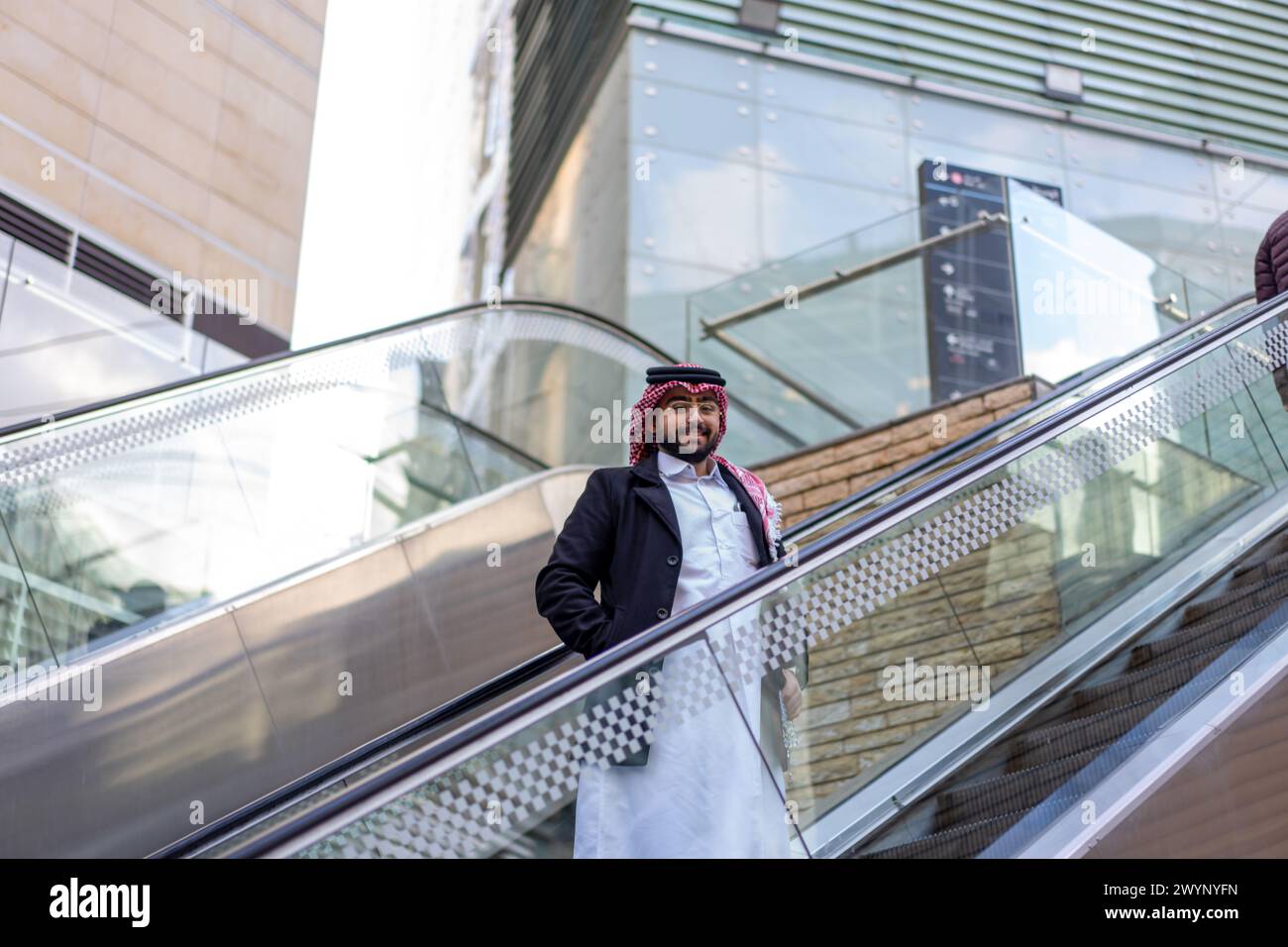 arabic man on escalator Stock Photo