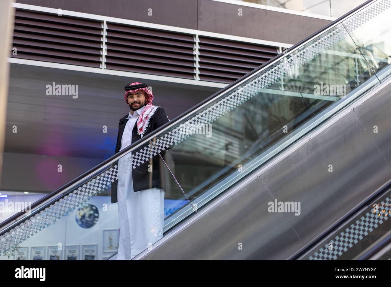 arabic man on escalator Stock Photo