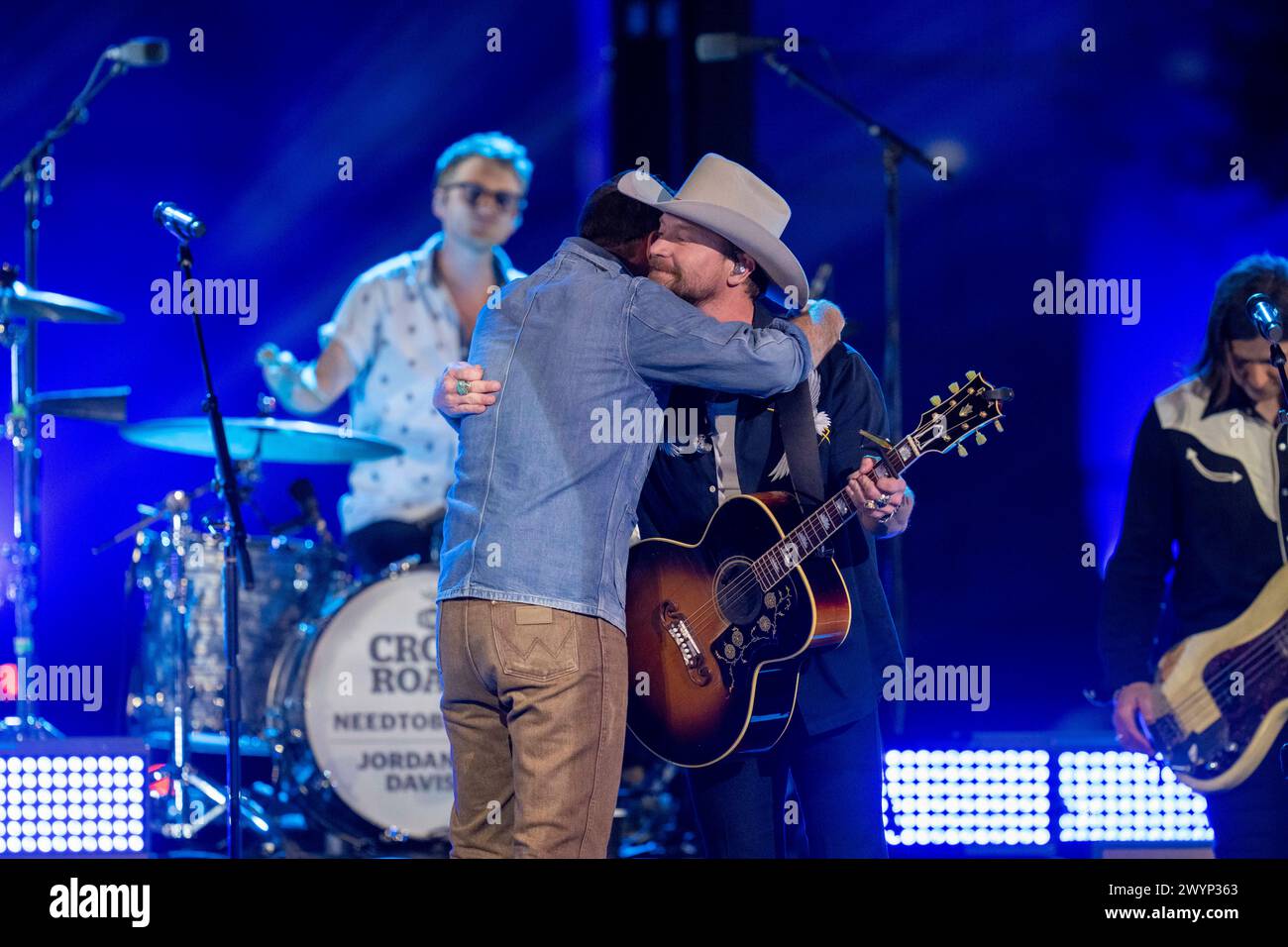 American country rock band NEEDTOBREATHE with lead singer BEAR RINEHART (wearing cowboy hat) teams up with country pop singer JORDAN DAVIS ( in blue shirt) at a taping of CMT Country Crossroads on the University of Texas campus on April 5, 2024. Credit: Bob Daemmrich/Alamy Live News Stock Photo
