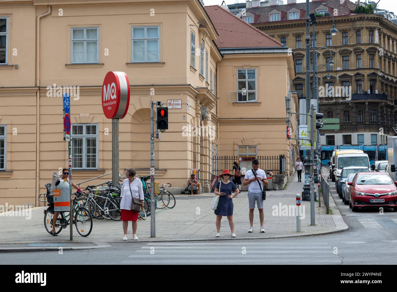Vienna, Austria - June 21, 2023: People at a pedestrian crossing waiting for a green light Stock Photo