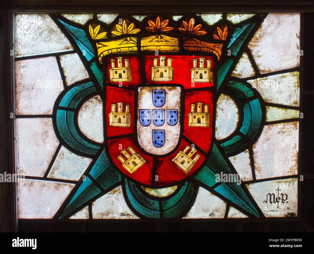 Coat of arms of the Kingdom of Portugal in a stained glass window of the Alcazar of Segovia Stock Photo