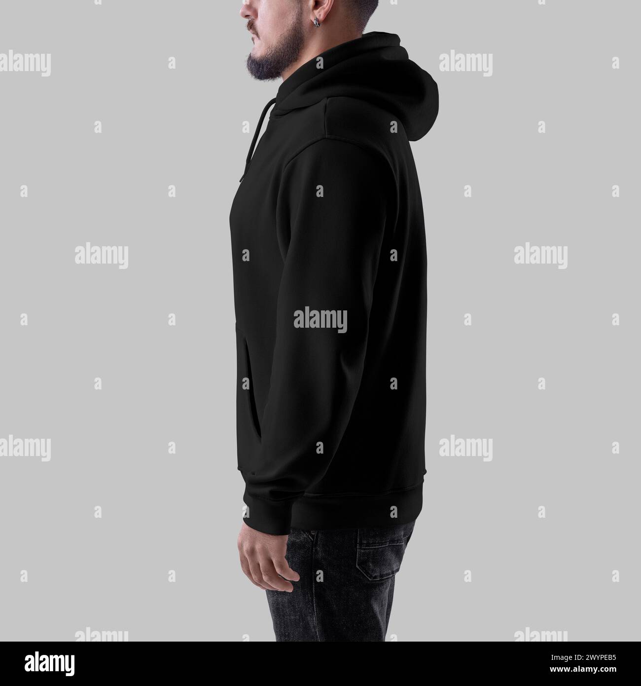 Template of black oversized hoodie on bearded man, side view, clothing with pocket, cuff, strings, isolated on background. Mockup of fashionable male Stock Photo