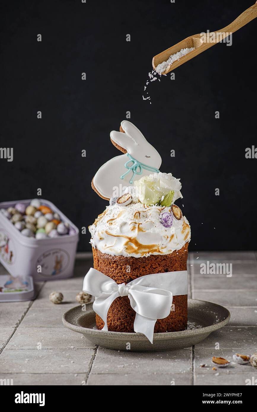 Easter cake on a dark background decorated with Easter chocolate eggs and Easter gingerbread rabbit Stock Photo