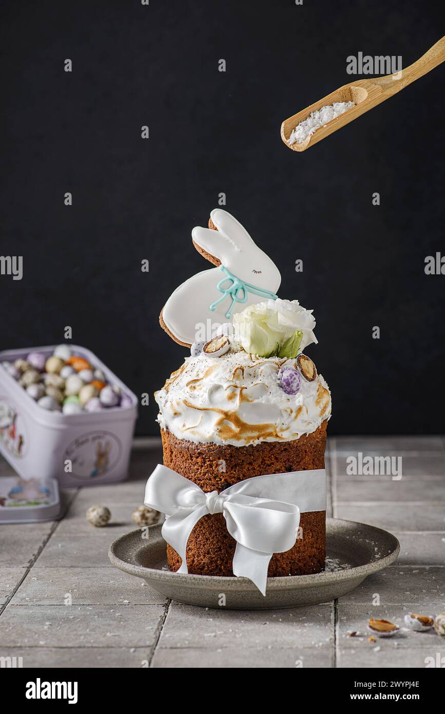 Easter cake on a dark background decorated with Easter chocolate eggs and Easter gingerbread rabbit Stock Photo
