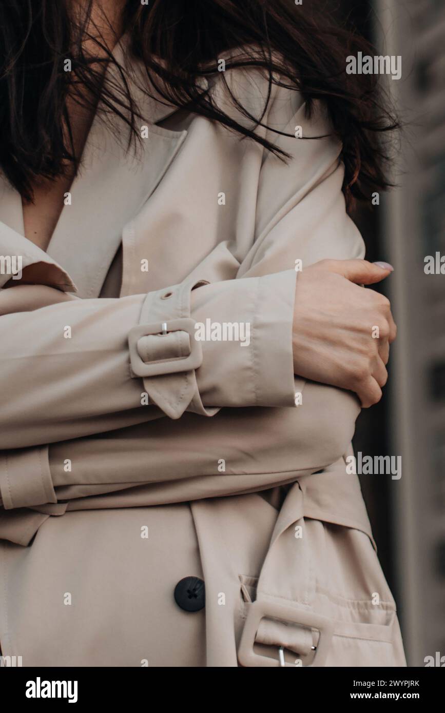 Fashion details of beige neutral seasonal trench coat. Street style fashion Stock Photo