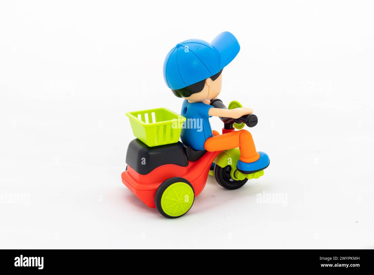 Toy boy with cap riding cycle isolated on white background Stock Photo Alamy