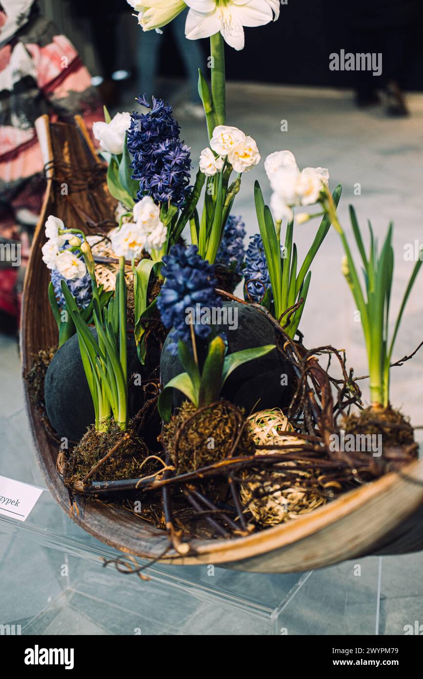 Innovative Spring Floral Arrangement in Wooden Vessel Stock Photo