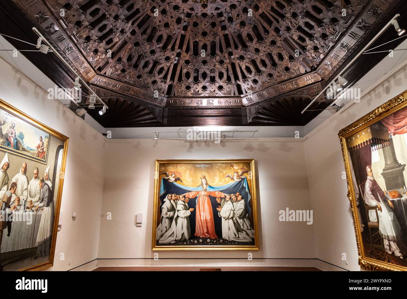 Interior of a painting gallery with ornate wooden carved ceiling at the Seville Museum of Fine Arts, Seville, Spain Stock Photo