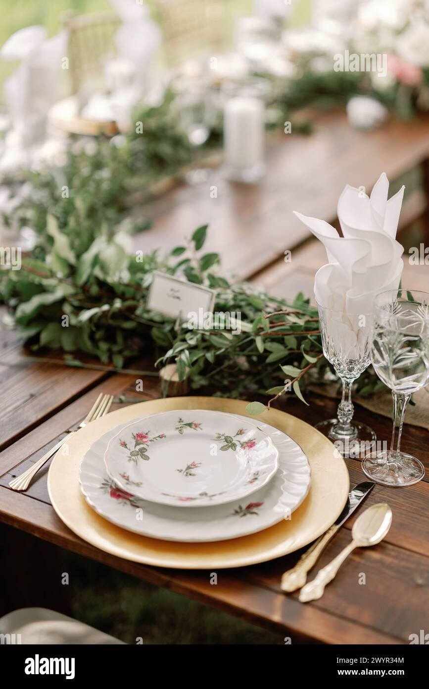 Rustic wedding table setting with golden accents Stock Photo