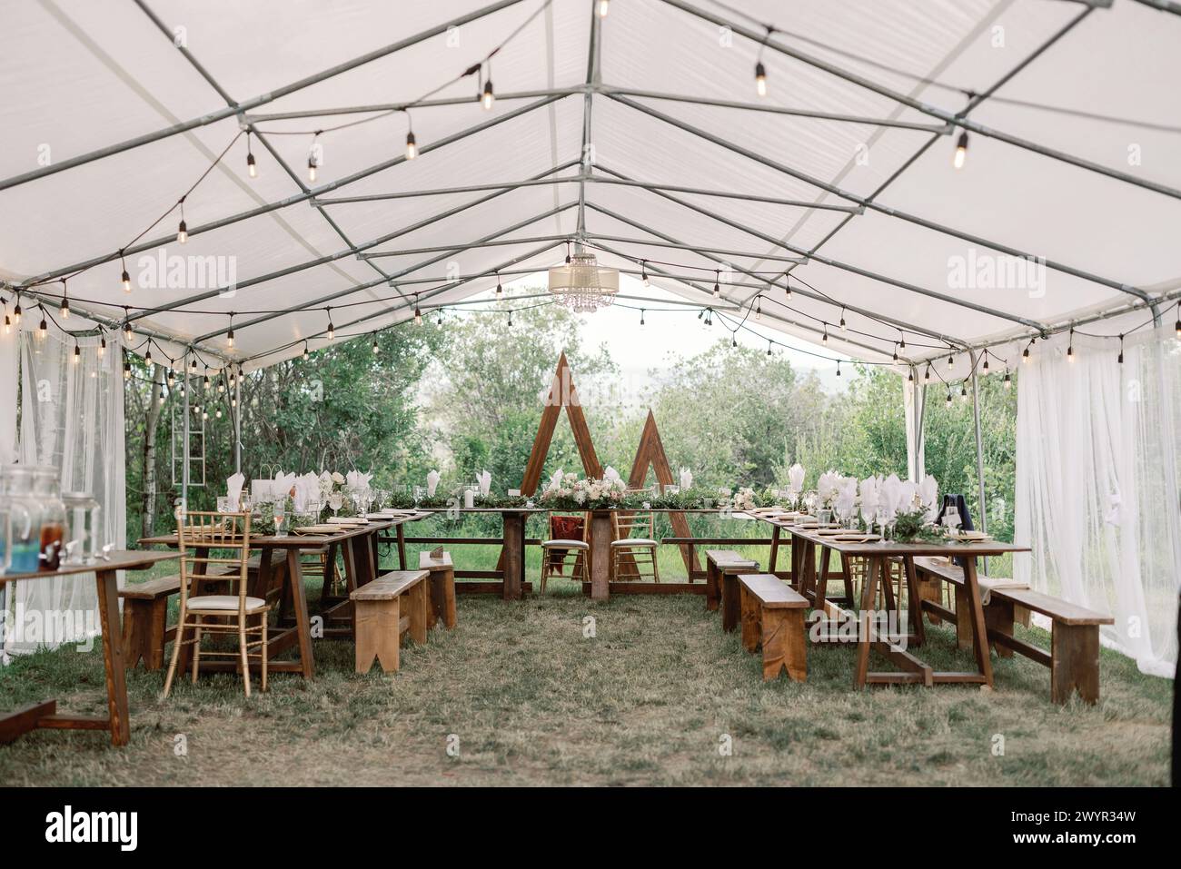 Elegant outdoor tented wedding reception setup Stock Photo